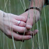 couple's hands in field