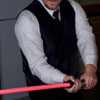 groom in jedi pose with lightsaber